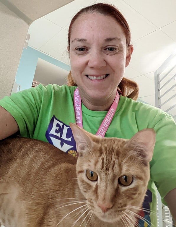 Kelly sitting with a cat